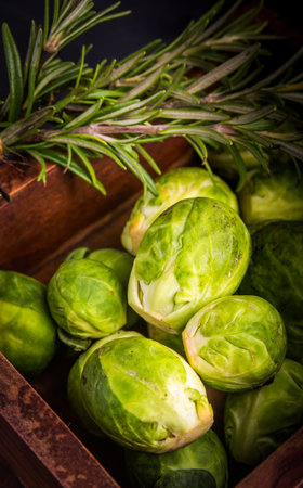 Brussels sprouts and rosemary in old wooden box