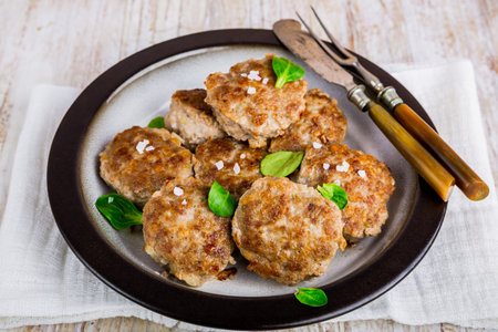 Fried pork meatballs on a plate sprinkled with salt