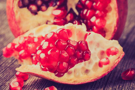 Vintage photo of pomegranates on wooden table