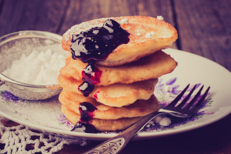 Vintage photo of pancakes with jam on plate