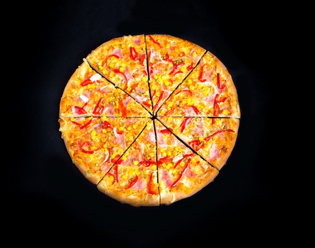 Pizza with peppers, corn and peas isolated on black backgroundの写真素材