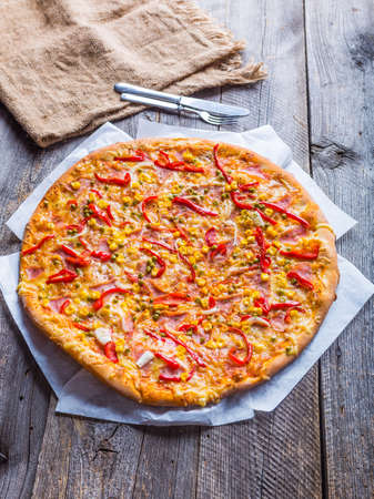 Delicious pizza with peppers, corn and peasの写真素材