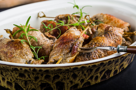 Pork rolls with rosemary on porcelain dishの写真素材