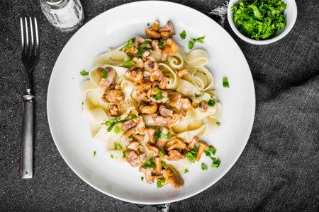 Pasta spaghetti with wild forest mushrooms chanterelle on white plateの写真素材