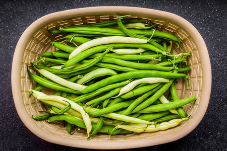 Green beans in a basket, top viewの写真素材