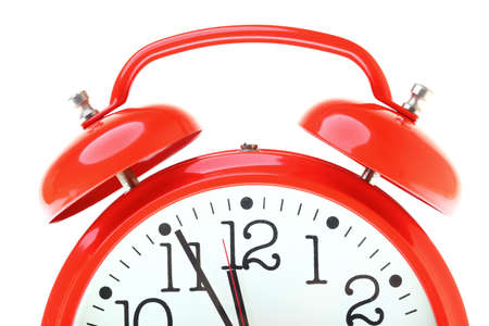 red old style alarm clock isolated on whiteの写真素材