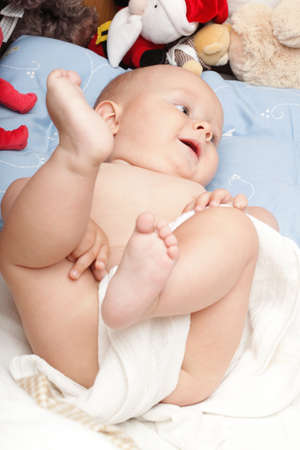 baby boy in diaper on white, blue eyeの写真素材