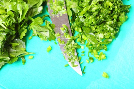 Twig of parsley and kitchen knife nature food texture background