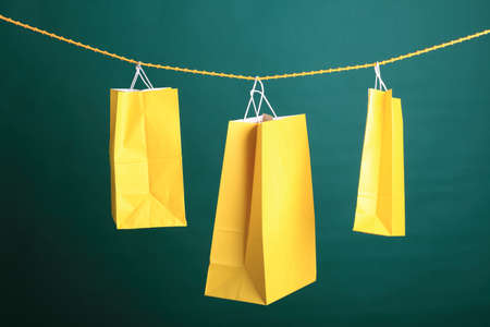 Shopping yellow gift bags on green backgroundの写真素材