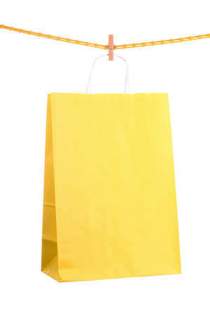 Shopping yellow gift bags isolated on white backgroundの写真素材