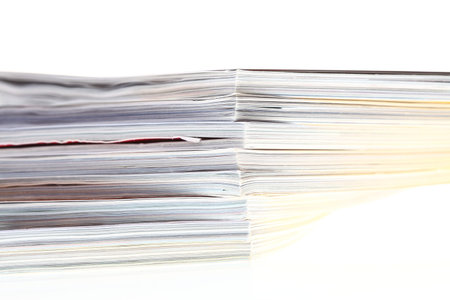 stack of magazines isolated over white backgroundの写真素材