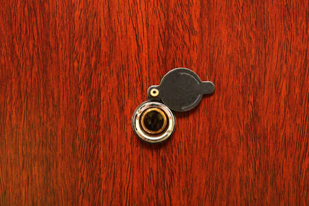 Peephole on wooden door - judas hole spyholeの写真素材
