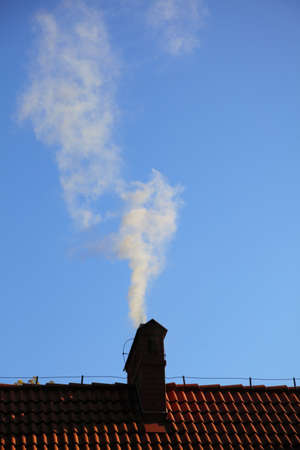 Smoke from a chimney sky blue nobodyの写真素材