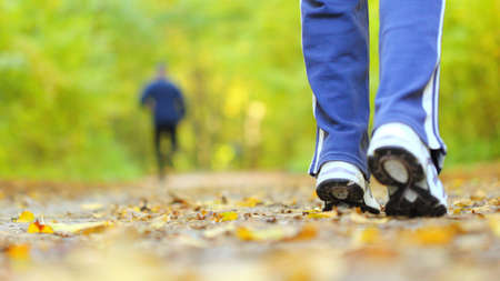 Woman walking cross country and trail in autumn forest Woman walking cross country and trail in autumn forest