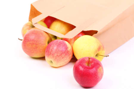 Shopping brown recycle gift bags and red apple isolated on white backgroundの写真素材