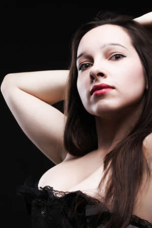 vintage brunette i- white corselette black backgroundの写真素材