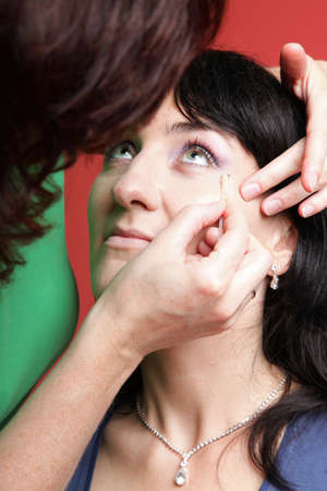 Close up of the woman paints face with makeupの写真素材