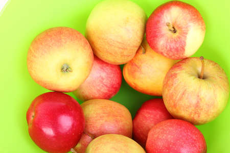 Fresh red apples in basket GREEN background.の写真素材
