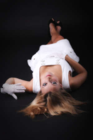 picture of beautiful blonde woman in white gloves black backgroundの写真素材