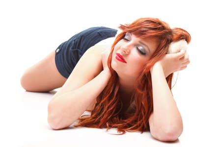 happy redhairy woman girl in white headphonesの写真素材