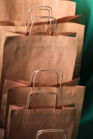 paper Shopping gift bags on green background ecologocal