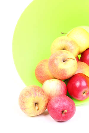 Fresh green, red apples in basket isolated over white background.の写真素材