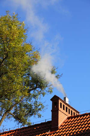Smoke from a chimney sky blue nobodyの写真素材