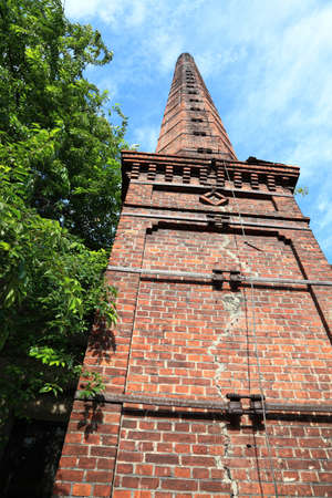 Smokestack of an old abandoned industrial complexの写真素材