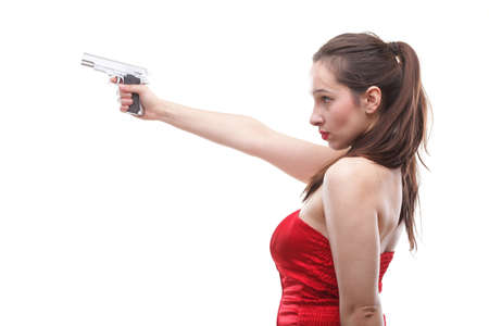 Sexy young woman in red with a gun isolated on whiteの写真素材