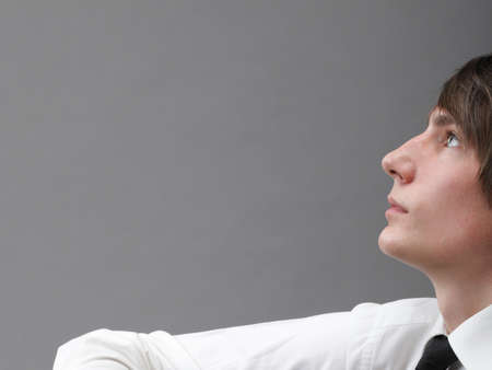 Young men with the on grey background. Love and reflection.の写真素材