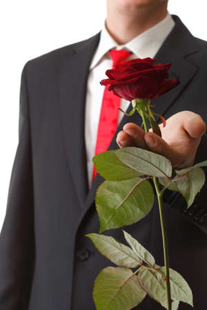 Young man presenting a flower - red rose isolated white backgroundの写真素材