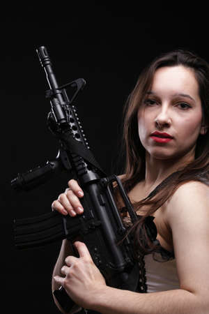 Sexy women - Girl holding an Assault Rifle, black backgroundの写真素材