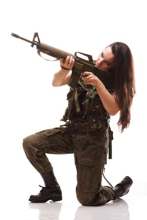 Beautiful woman with rifle plastic Military Army girl Holding Gun white isolated backgroundの写真素材