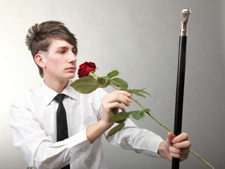 Portrait of a young man grey background. Love and rose.の写真素材