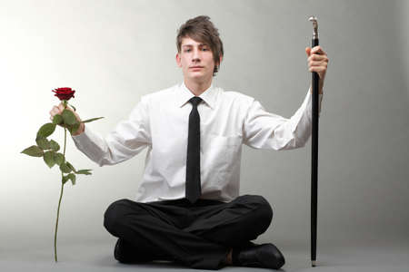 Portrait of a young man grey background. Love and rose.の写真素材