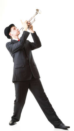 Portrait of a young jazz man playing his Trumpet white backgroundの写真素材