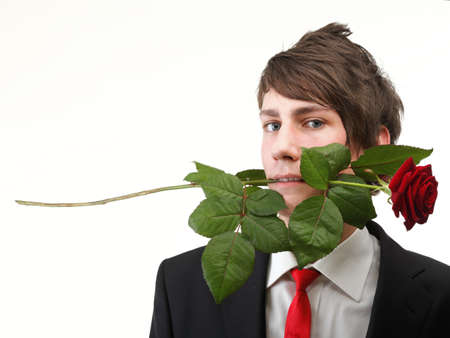 Young handsome man with flower, red rose isolated white backgroundの写真素材