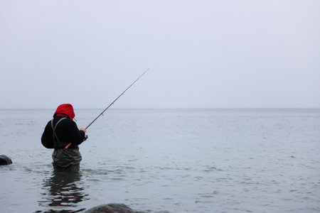 Fisherman in sea water autumn outdoor relax