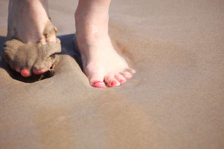 nice legs in water, nice pedicure red nail sand beachの写真素材