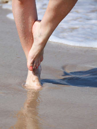 nice legs in water, nice pedicure red nail sand beachの写真素材