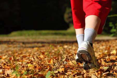 Woman walking cross country and trail in autumn forest Woman walking cross country and trail in autumn forest
