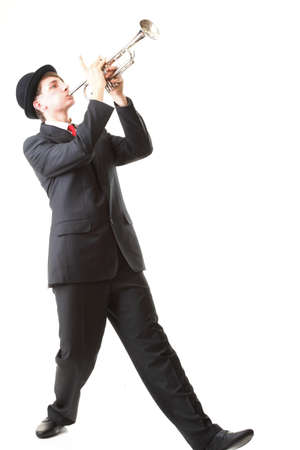 Portrait of a young jazz man playing his Trumpet white backgroundの写真素材