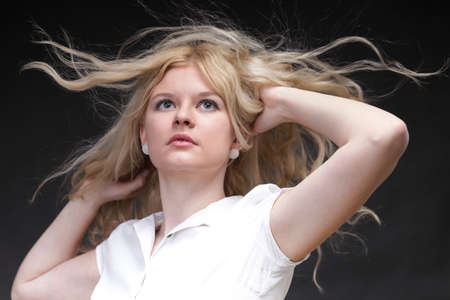 Blonde woman with her hair blowing in the windの写真素材