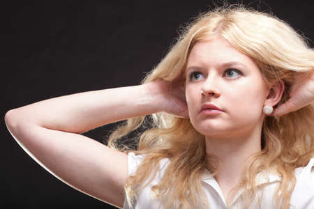 portrait of beautiful blonde woman black backgroundの写真素材