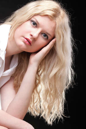 portrait of beautiful blonde woman black backgroundの写真素材