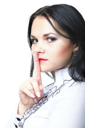 Young woman brunette girl asking for silence white isolatedの写真素材