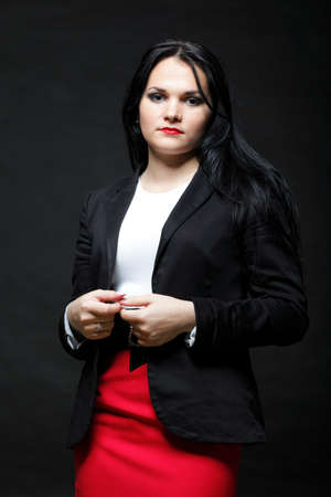 portrait of smiling modern business woman in red dressの写真素材