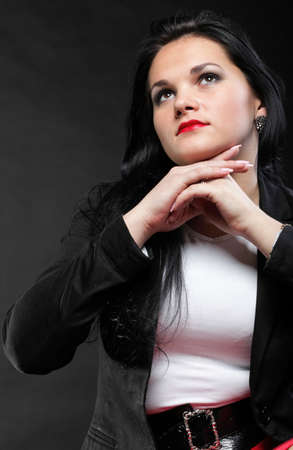 portrait of beautiful young brunette on black background.の写真素材