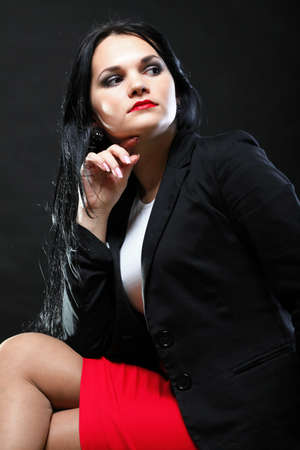 portrait of beautiful young brunette on black background.の写真素材
