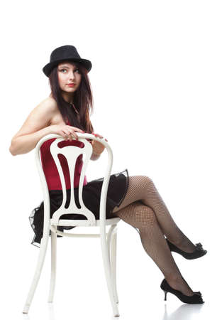 entertainment pastime girl dance in red corset chair white isolated showgirl,の写真素材